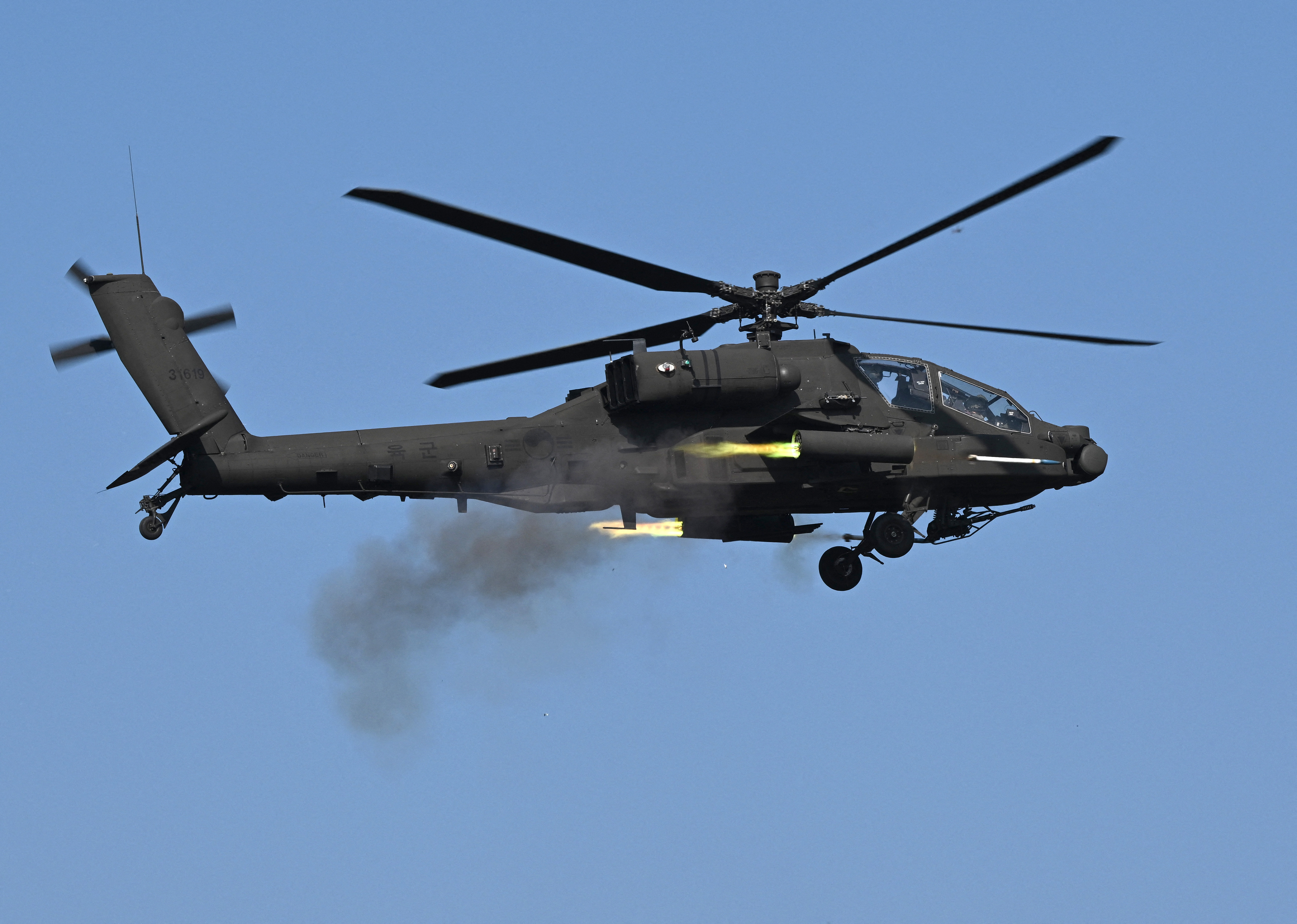 A South Korean AH-64 Apache helicopter fires rockets during a combined live-fire exercise between the South Korean and US armies at the Rodriguez Live Fire Complex in Pocheon on October 30, 2024. (Photo by Jung Yeon-je / AFP) (Photo by JUNG YEON-JE/AFP via Getty Images)