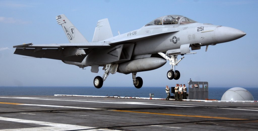Landing Signal Officers (LSO) watch as an F/A-18F Super Hornet assigned to Strike Fighter Squadron (VFA) 106, prepares to make an arrested recovery aboard the Nimitz-class aircraft carrier USS Harry S. Truman (CVN 75). Truman is underway conducting carrier qualifications in the Atlantic Ocean.